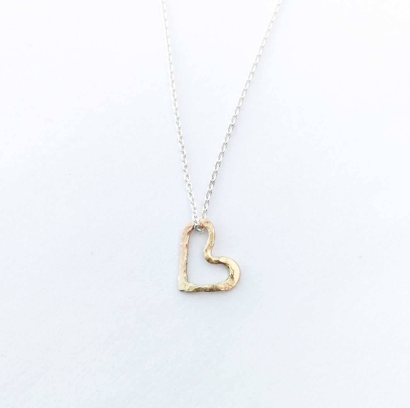 A close up image of the gold Openhearted Pendant