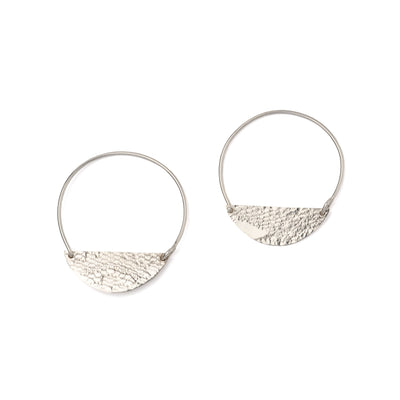 An image of the Waxing Half Moon Hoops with a lace imprint