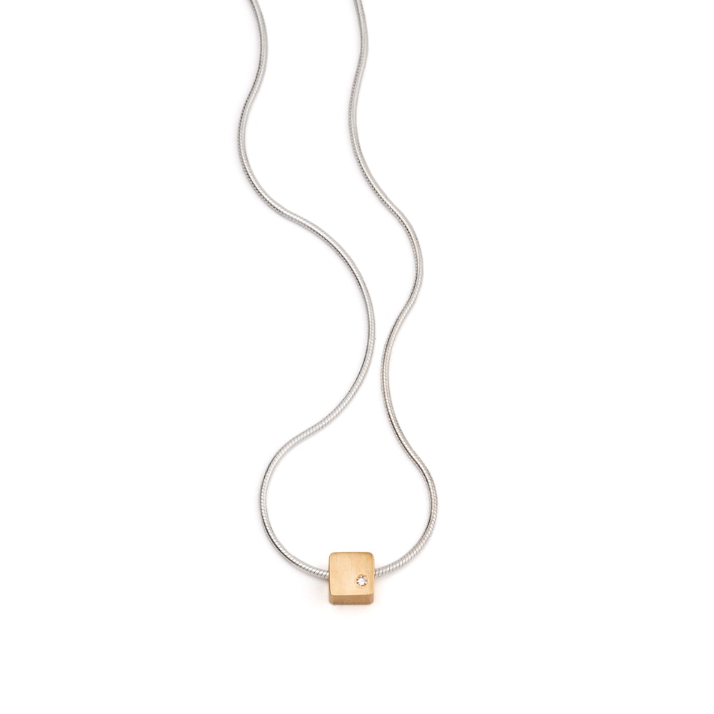 A close up image of the Gold Cube Bead with a Diamond on a snake chain