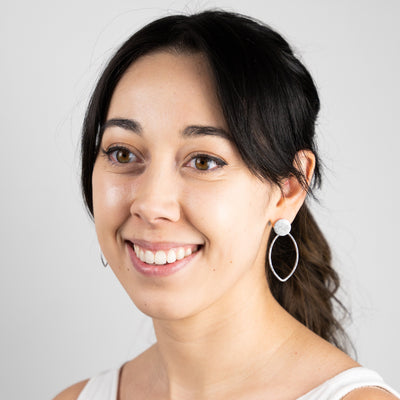 An alternate angle of the Pointed Oval Petal Earrings worn on the body