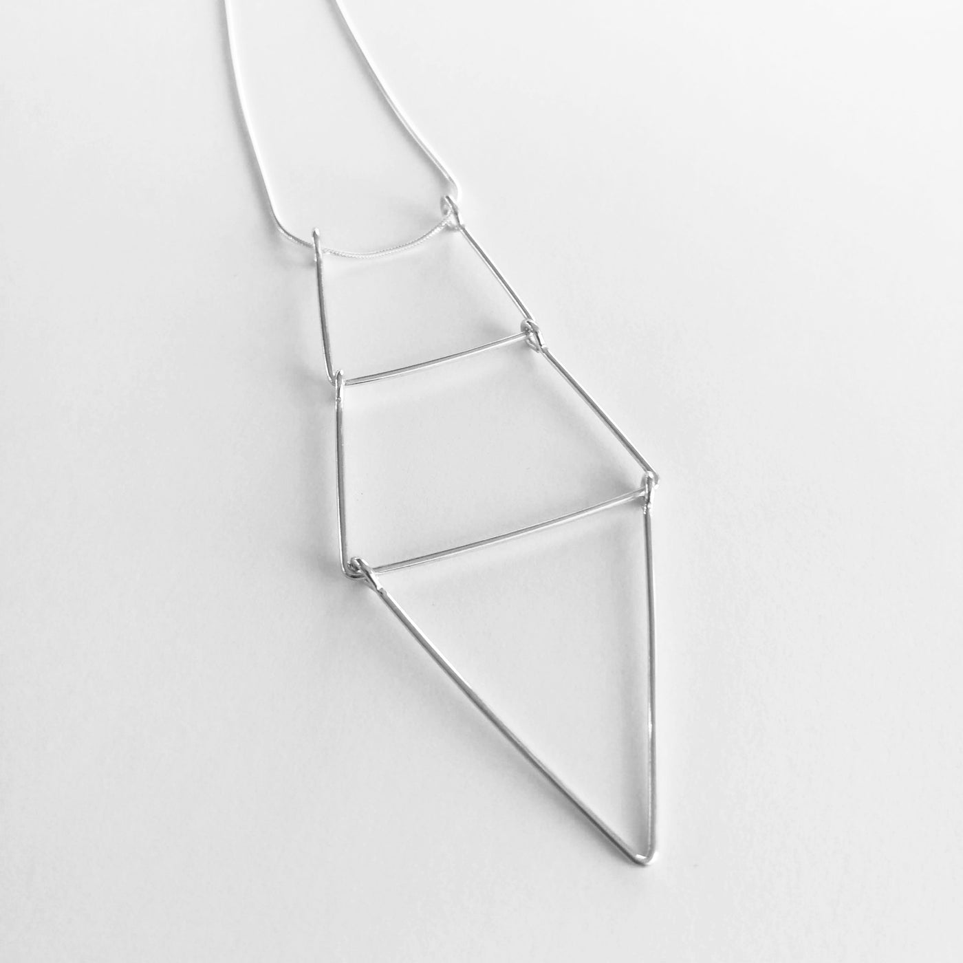 A close up image of the Kinetic Ladder Pendant