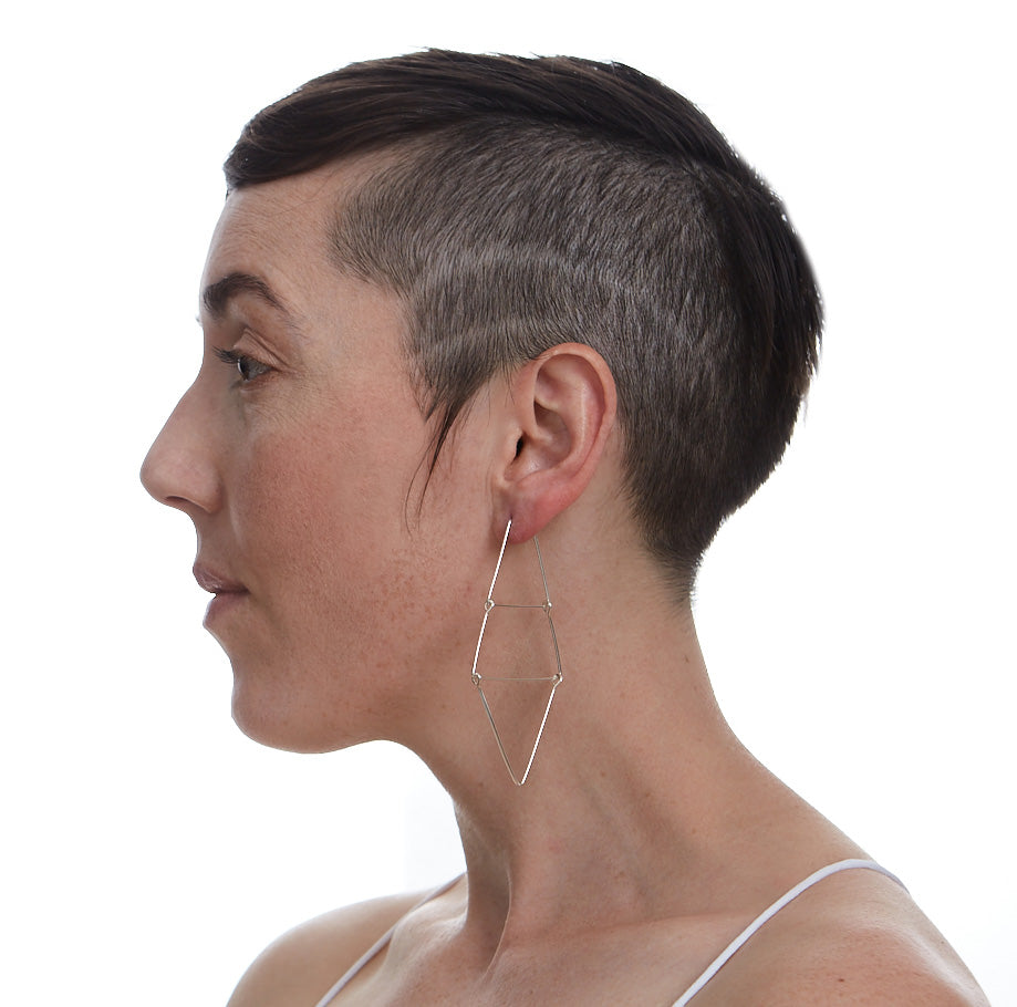 An image of the Kinetic Ladder Earrings worn on the body