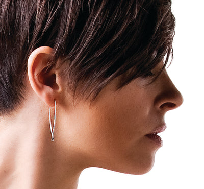 An image of the silver Quill hoops worn on the body