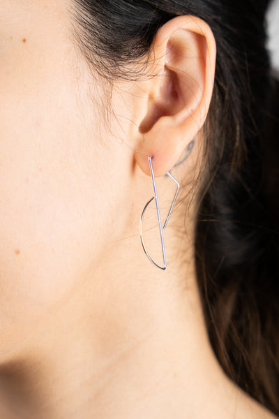 A close up image of the Reflect Hoops worn on the body